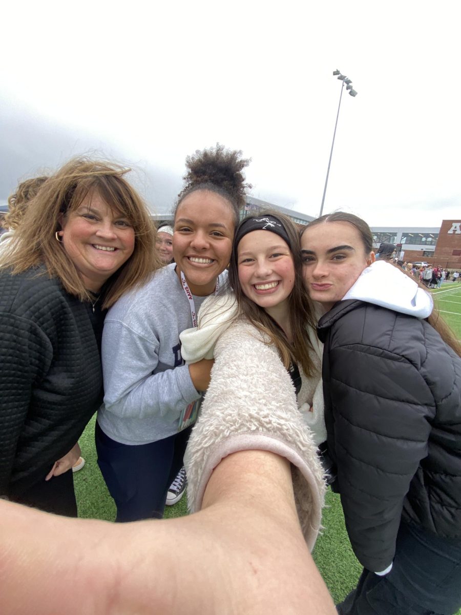 All Smiles. Taking the selfie opportunity, Mrs. Hogan runs around the student crowd at the 2023 Turkey Bowl, attempting to get pictures with as many kids as possible. To keep up with the trends, Hogan got a 0.5 picture with juniors, Isabella Graham, Addisen McDonald, and Haley Tanzi.