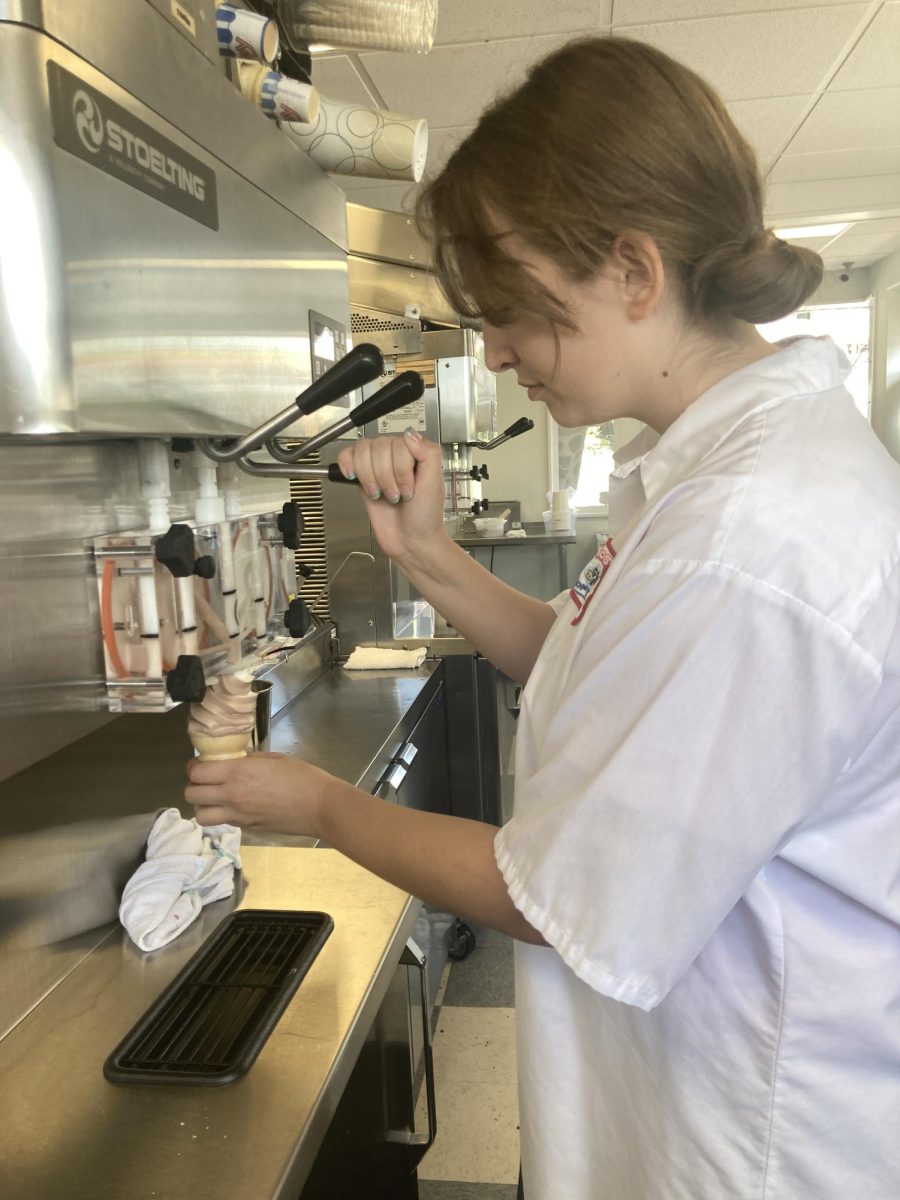 Sweet Swirl. Senior Ava Rokosky  carefully swirls the soft serve ice cream onto a cone during her summer job at Frosty Cow. Ice cream stores often provide just seasonal employment, an opportunity students are able to take advantage of during their break. 
