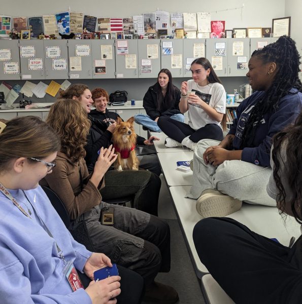 Puppy Love. Wanda Vanishs dog, Rusty, sits quietly on Olivia McMinns lap as she plays a card game as part of team building with fellow yearbook staff members. Vanish and history teacher John Saboe have brought their personal dogs in for trial run days. 