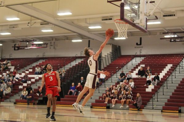 Sophomore Roan Greaser goes for the fast break layup after stealing the ball on defense. Greaser was the high scorer of the game for the Mountain Lions with 14 points. 
