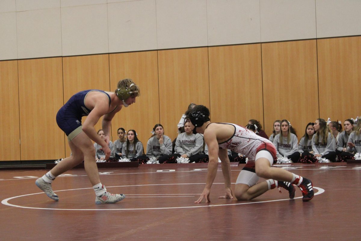 Lowering+the+stakes.+freshman+Gavin+Ciampoli+lowers+his+level+to+get+a+takedown+on+his+opponent+om+Jan.+31.+Gavin+won+this+match+and+improved+his+record+to+17-6.