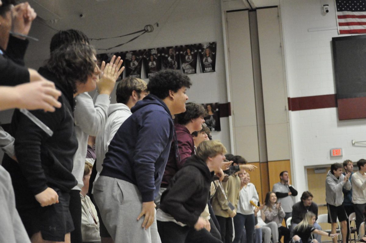 Celebration. Students cheer on the wrestling team following a point being scored against Williamsport. 