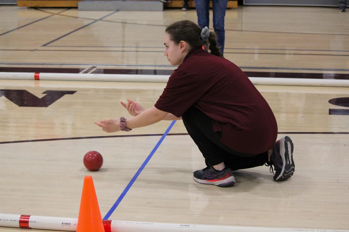 Focus. Junior Victoria Wukovich kneels down to aim the ball. The tournament consisted of five rounds. 
