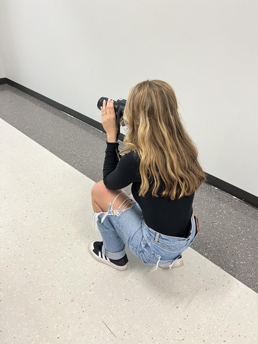 In the zone. Horseshoe Yearbook staff member Aleah Layton practices photography during a session with Chuck Meyers. 