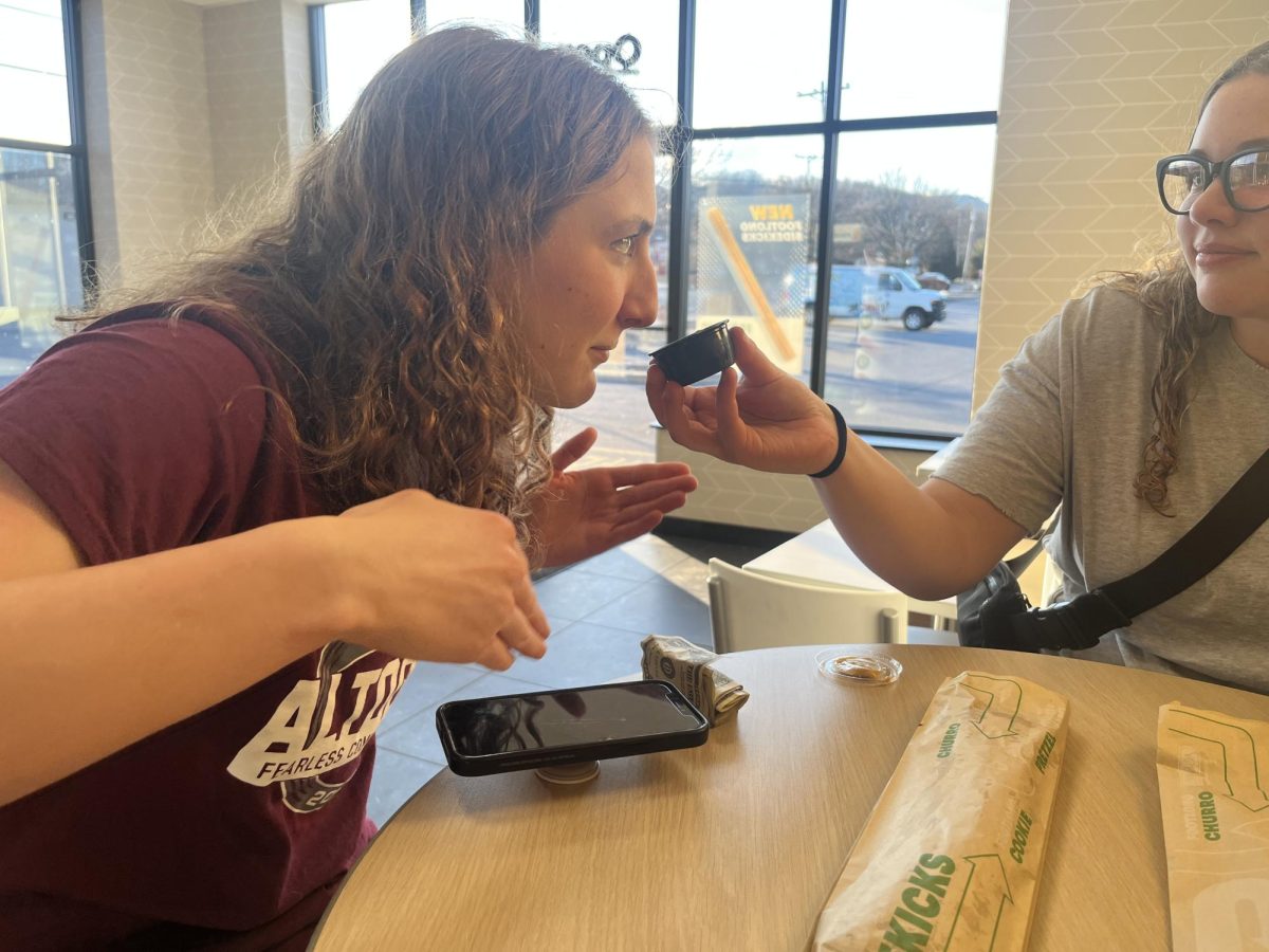 Wafting. Reporter Charlie Kephart holds the honey mustard sauce while Gracie Gioiosa wafts it. Reporter Cider Ayala tagged along to help try the Subway Sidekicks. 