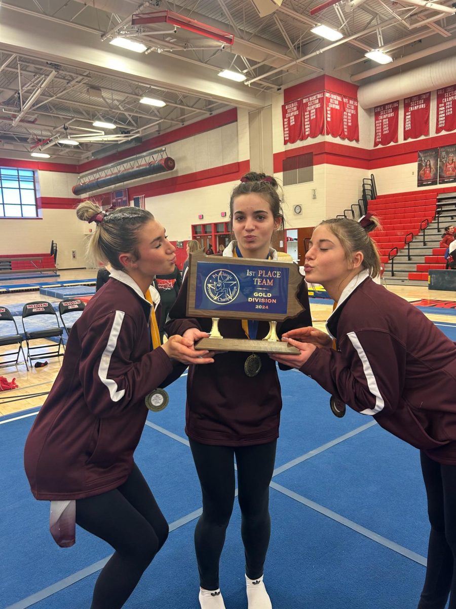 Kisses for the win. Senior Delaney Barr and juniors Isabella Bush and Maddy Pastore kiss for the picture. The team won first place. 