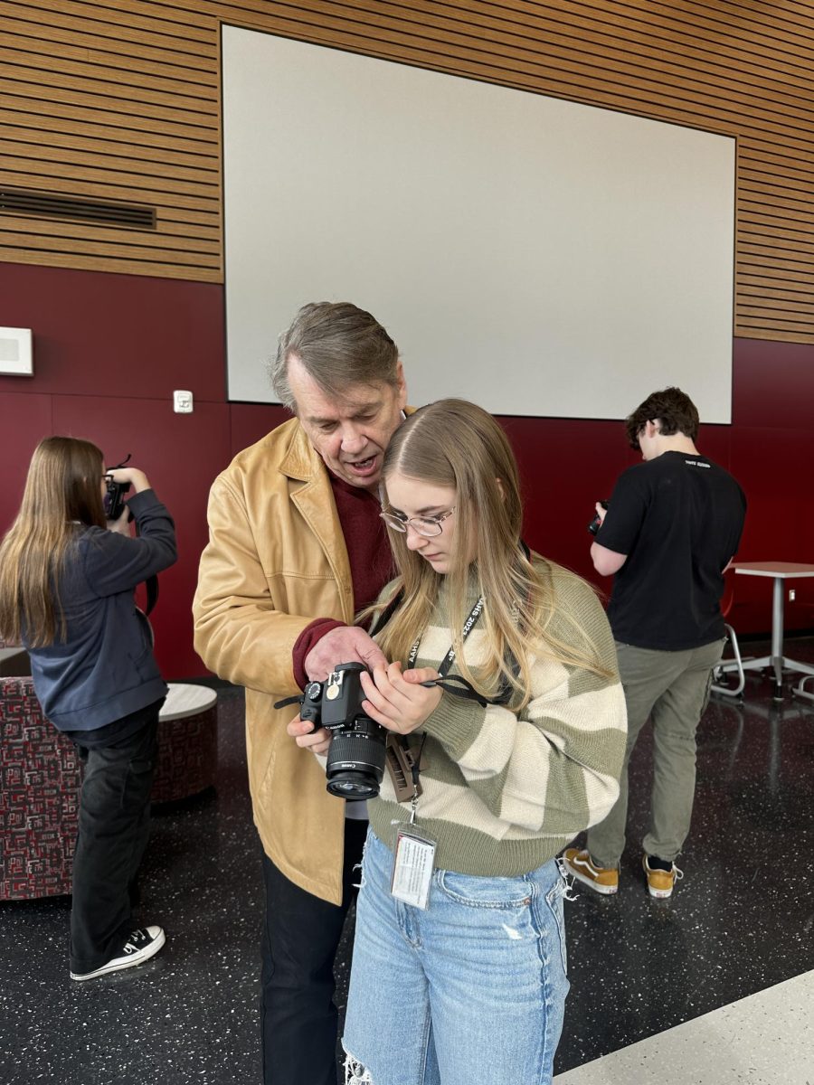 Behind the lens. Senior Lillian Roberts asks for photography tips from Tim Boyles. He has been working closely with students on the Mountain Echo staff. 