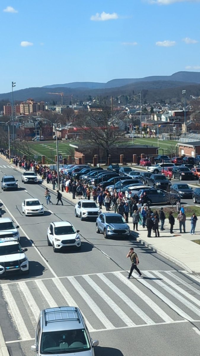 Parents line up outside of the high school to get their kids after the hoax call in March of 2023. 