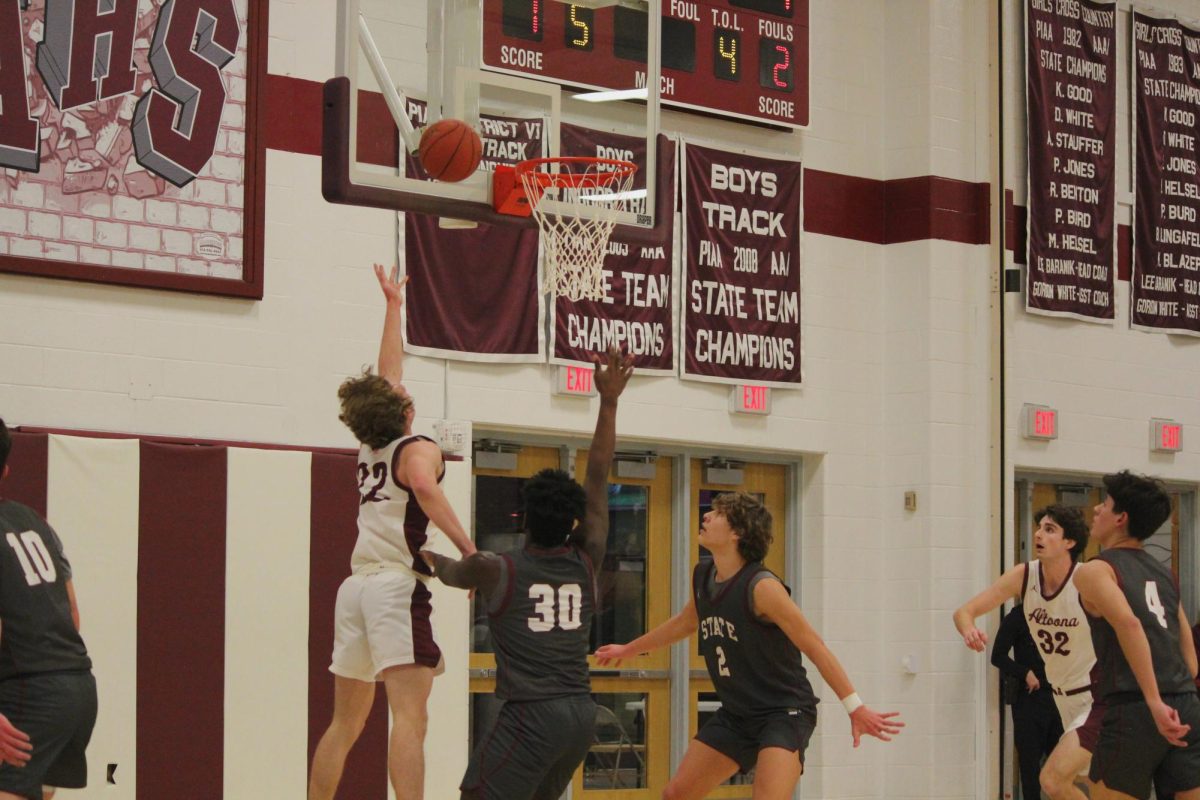 Dunk. Mountain Lions play against State College on Jan. 13. Kendra Pfeffer and Ellaina Saylor were present at this game, ensuring things ran smoothly. 