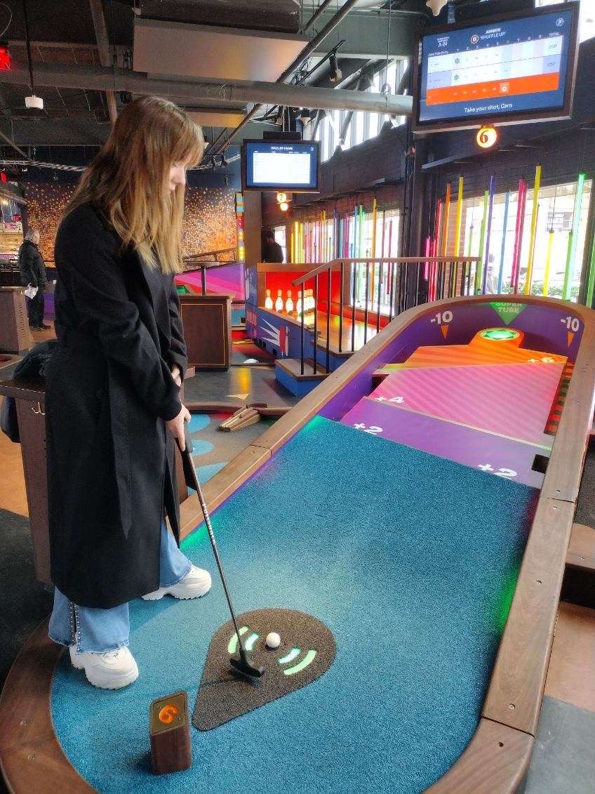 Preparing her putter, Senior Camryn MacAlarney mini golfs on the FLC trip to the Pittsburgh market in December MacAlarney is president of FBLA and Secretary of Astronomy club, as well as an AP and Honors Society student. 