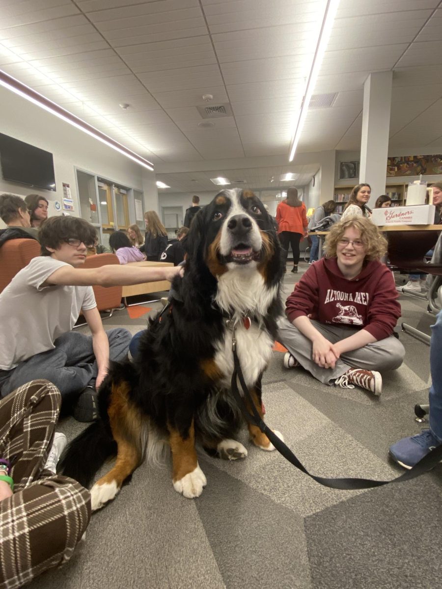 A Helping Hand. On Feb. 29 Mr. Saboes dog McKinley gets pet and surrounded by students trying to pet her. The therapy dogs come in every other Thursday in the library from the beginning of 5th to the end of 7th period.