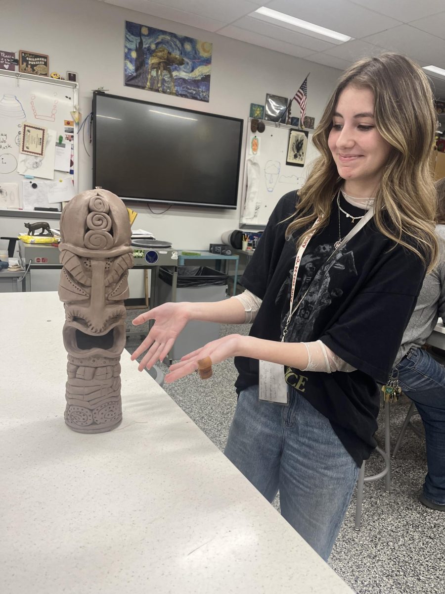 Reaching the Stars 
Junior Ava Cabell shows off her pottery project of a standing tiki. Cabells project is one of the tallest pieces that pottery teacher Eric Hoover has ever seen in his class.