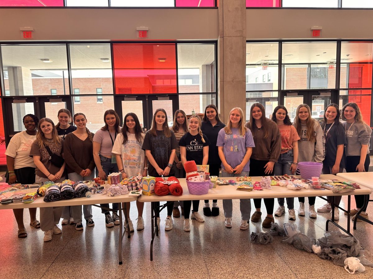 Ready, set, build! Girls League gathers around the table before building the baskets for Easter for Eli. Everyone was excited to help make a difference.
