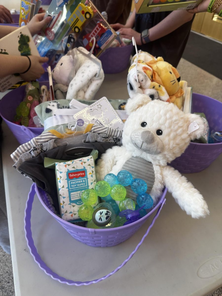 Baby basket. The youngest age range for the baskets was newborn to four years old. The baby basket contained items like teethers, clothes and a stuffed animal for the babies to hold. 