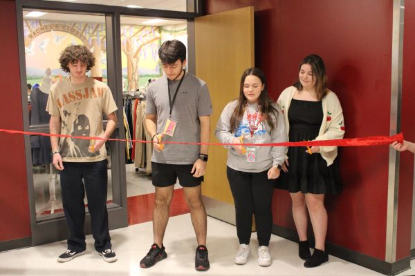 Continuing a legacy. Students join together to cut the ribbon of the opening of Rachel’s Closet. A new mural was painted inside for students to see while in the store. 