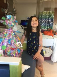 Happy hearts. A child in the hospital shows her heart-warming smile after receiving an Easter for Eli basket. The basket was filled with toys, games and other items to keep her entertained during her stay. 