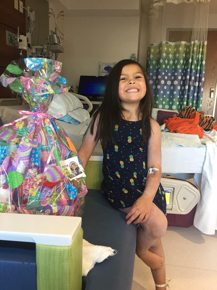 Happy+hearts.+A+child+in+the+hospital+shows+her+heart-warming+smile+after+receiving+an+Easter+for+Eli+basket.+The+basket+was+filled+with+toys%2C+games+and+other+items+to+keep+her+entertained+during+her+stay.+