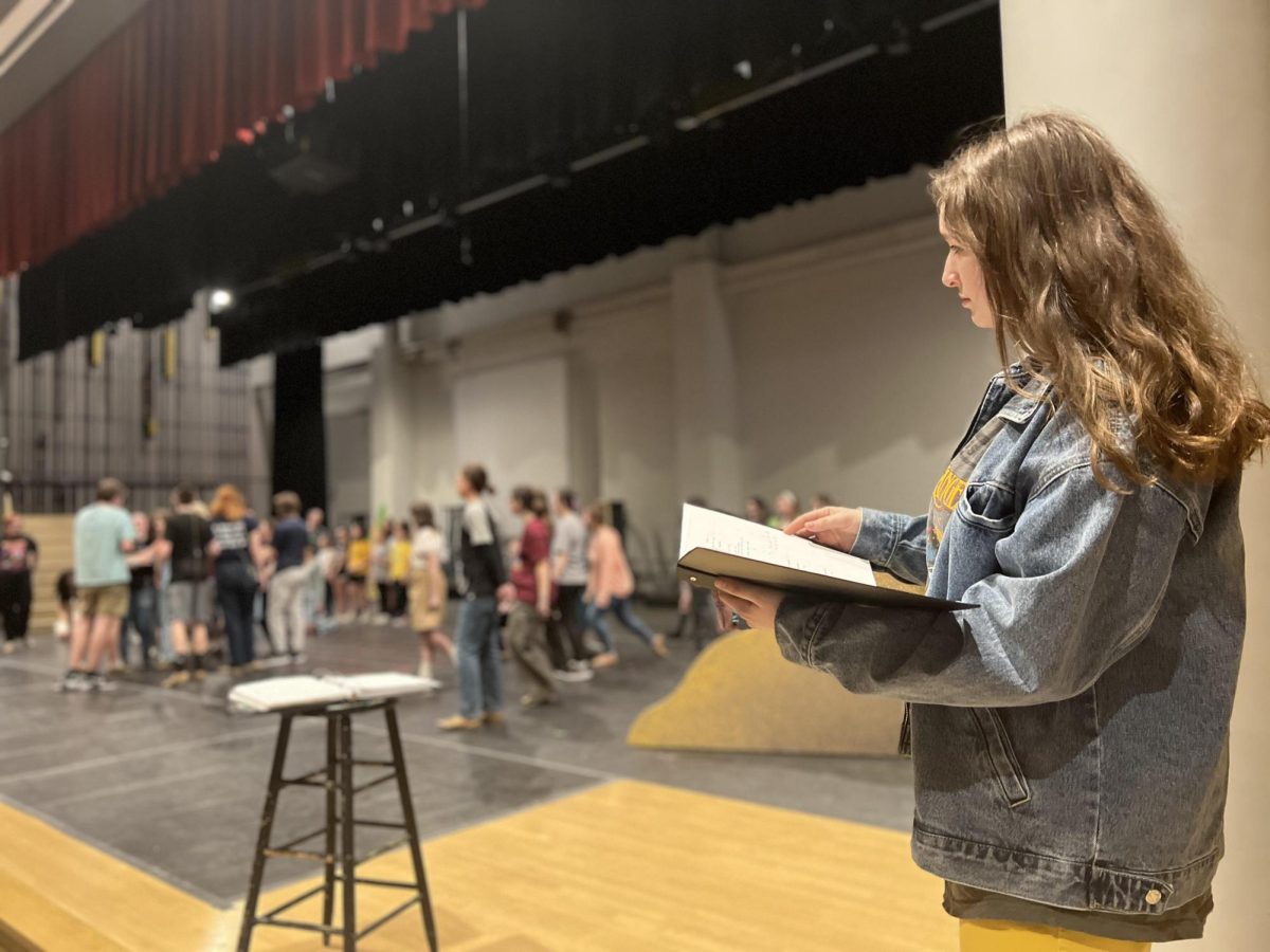 The show goes on. Senior Ava Rokosky takes notes during the drama club rehearsal. She is the student director for the Spring musical Joseph and the Amazing Technicolor Dreamcoat. 