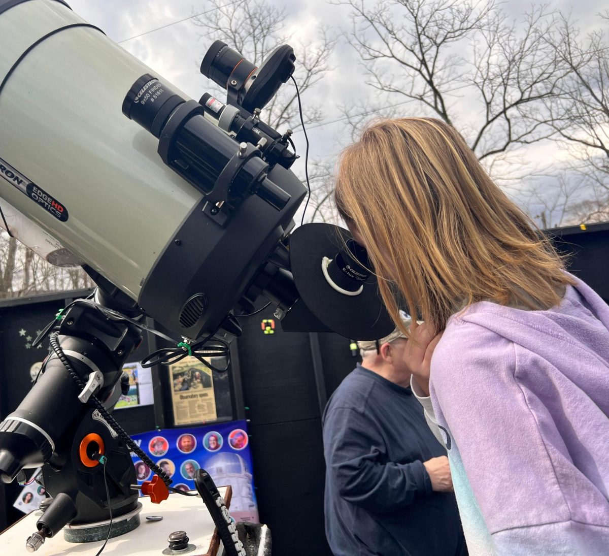 Look to the stars. Freshman Abigail Ford views the April 8th solar eclipse through a high-powered telescope. She traveled several states to view the eclipse with her family in Altoona. 
