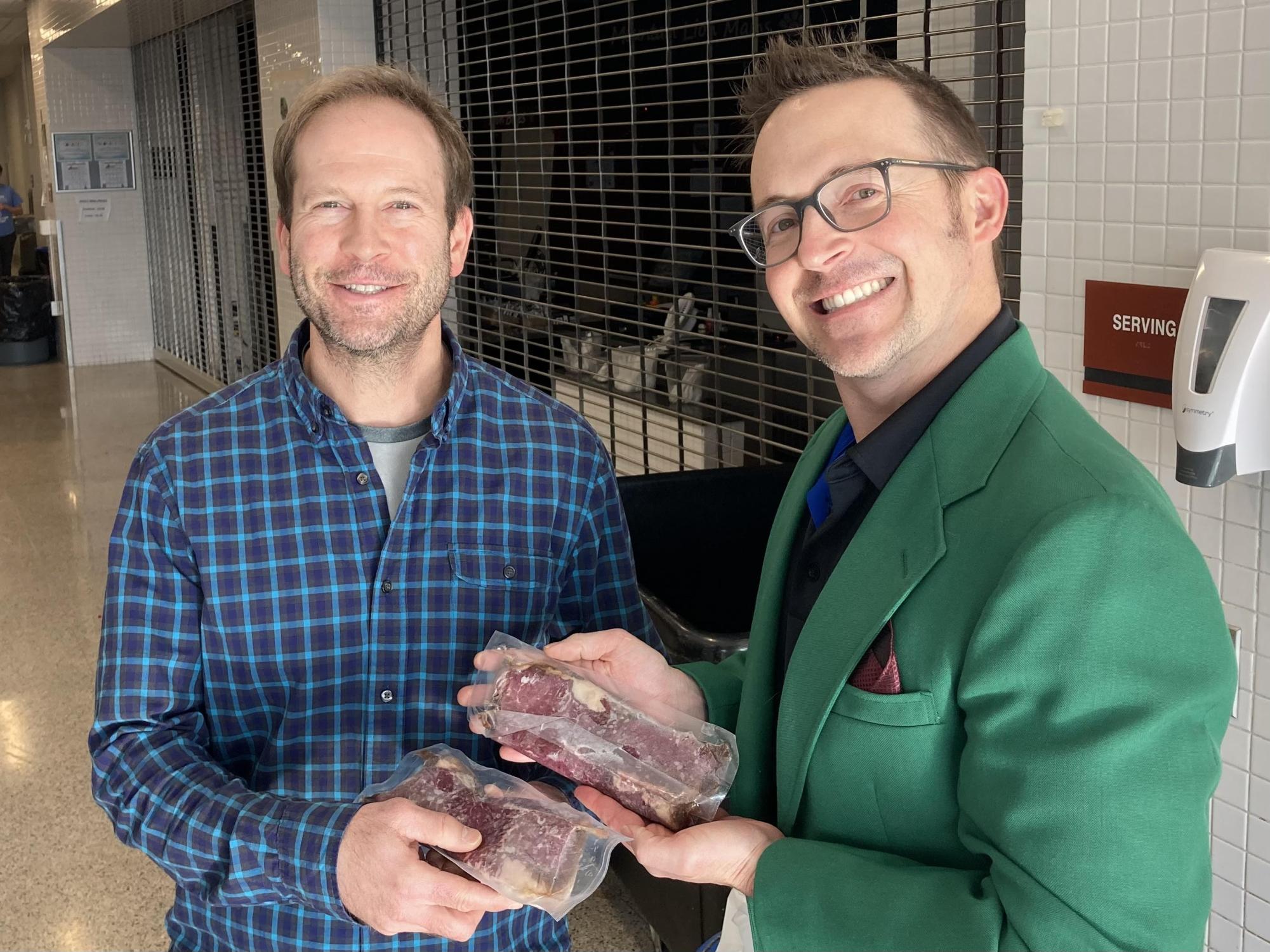 Steaks. Business teacher Christopher King accepts his MEAT award from Krug. The award is aimed to boost teacher morale.