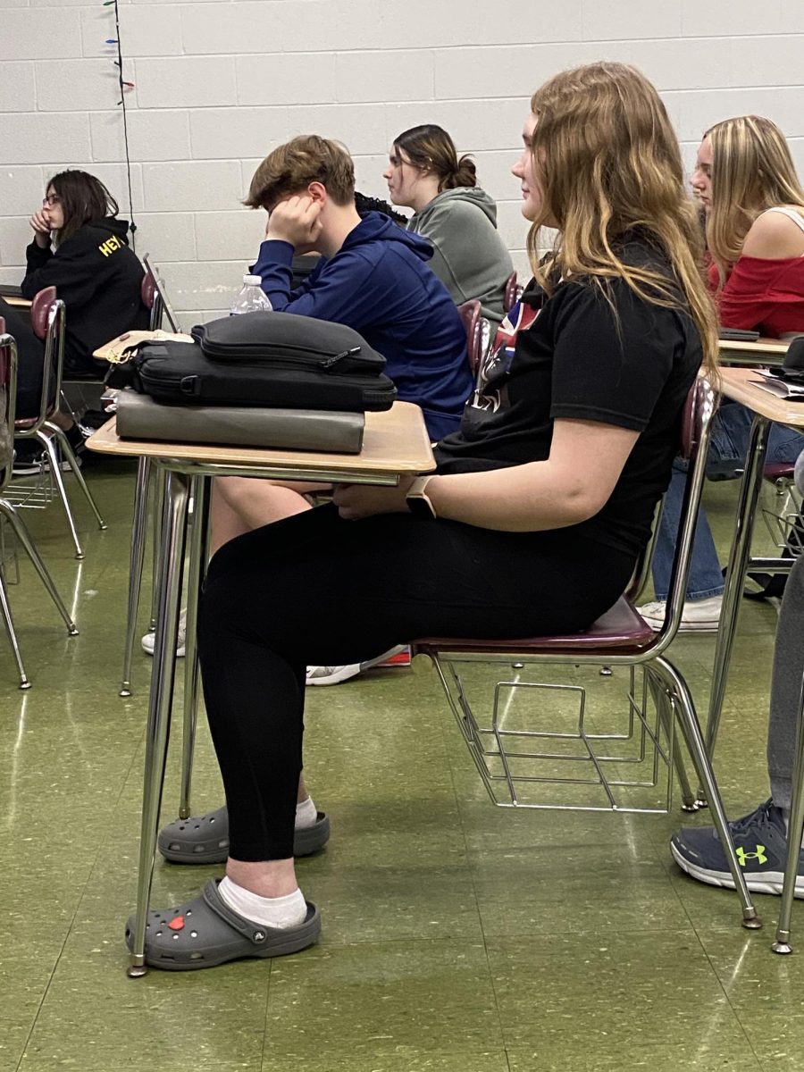 Watching a Manie Musicale reveal video, freshman Ruth Cron sits in her French I class with teacher Veronica Skomra. Cron enjoys learning French and participated in Manie Musicale for the first time this school year.  