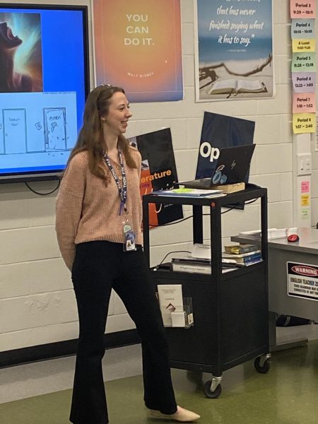 Vocab Builder. In her first period class, Caroline Clontz introduces the word of the day to her AP Literature students. She presents the word and its definition, along with two example sentences. 