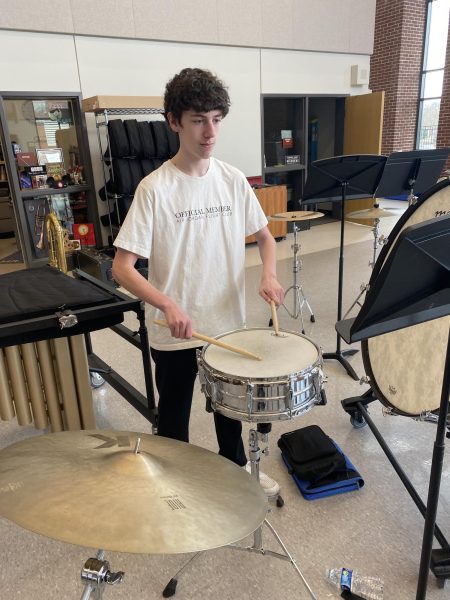 Drumming the Beat. Freshman Nick Boose does a buzz roll on the snare drum keeping the whole band in time. 