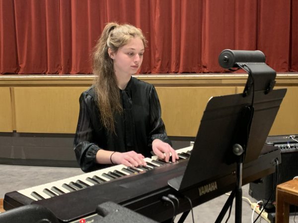 Music. Sophomore Isabella Abbott warms up prior to the closing night performance of Joseph and the Amazing Technicolored Dreamcoat. She played the Keyboard I part in the Pit Orchestra.