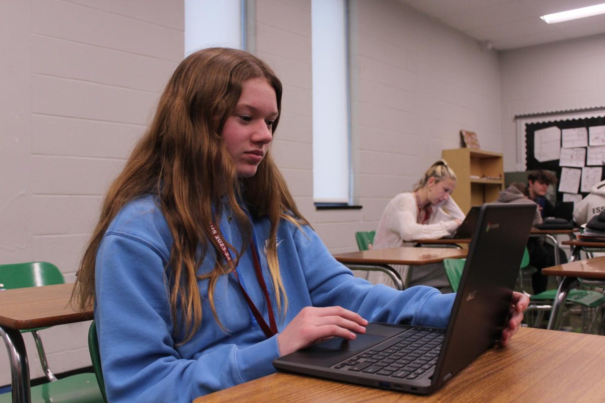 Working hard or hardly working? Sophomore Sofia Hallinan works on designing her yearbook spread for Introduction to Publications class during her free time. Outside of school, Hallinan is involved in multiple activities and sports, including the golf team and Swim team. 
