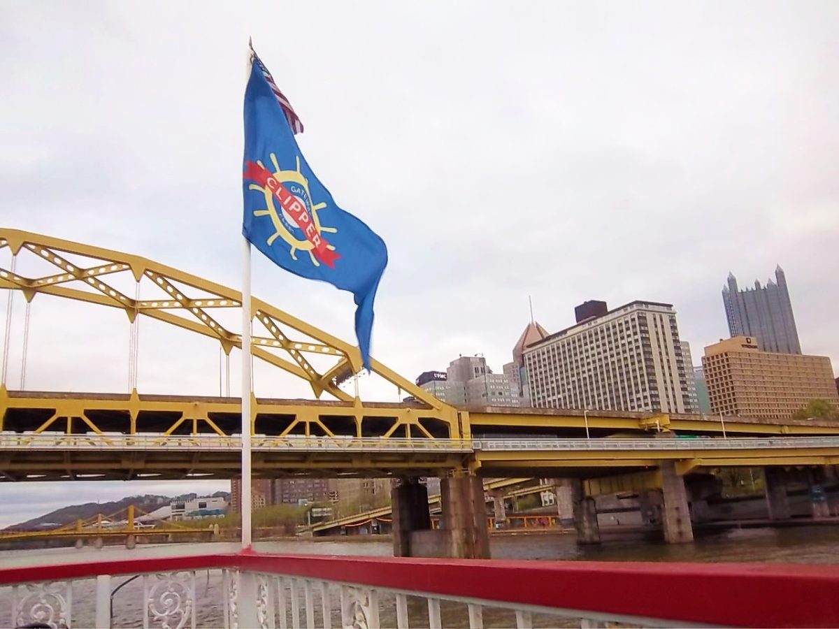 The Gateway clipper sails under the Fort Pitt Bridge while students watch the city on the top deck. 