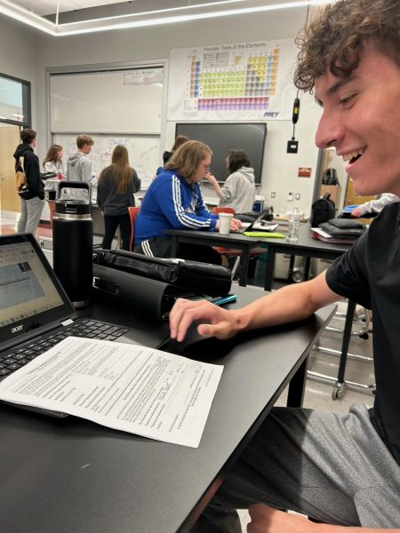 Anticipation. Junior Brandon Lyle smiles gleefully as he signs his paper to go on 2024s annual Canoe Creek trip. This years trip will have some minor changes to improve quality of life on the trip.