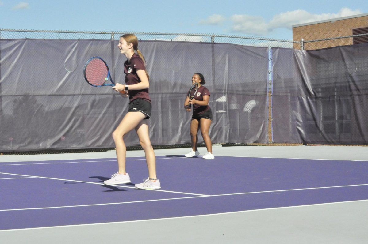 Get ready. Juniors Courtney Irwin and Isabella Graham prepare for a tennis match to start. 