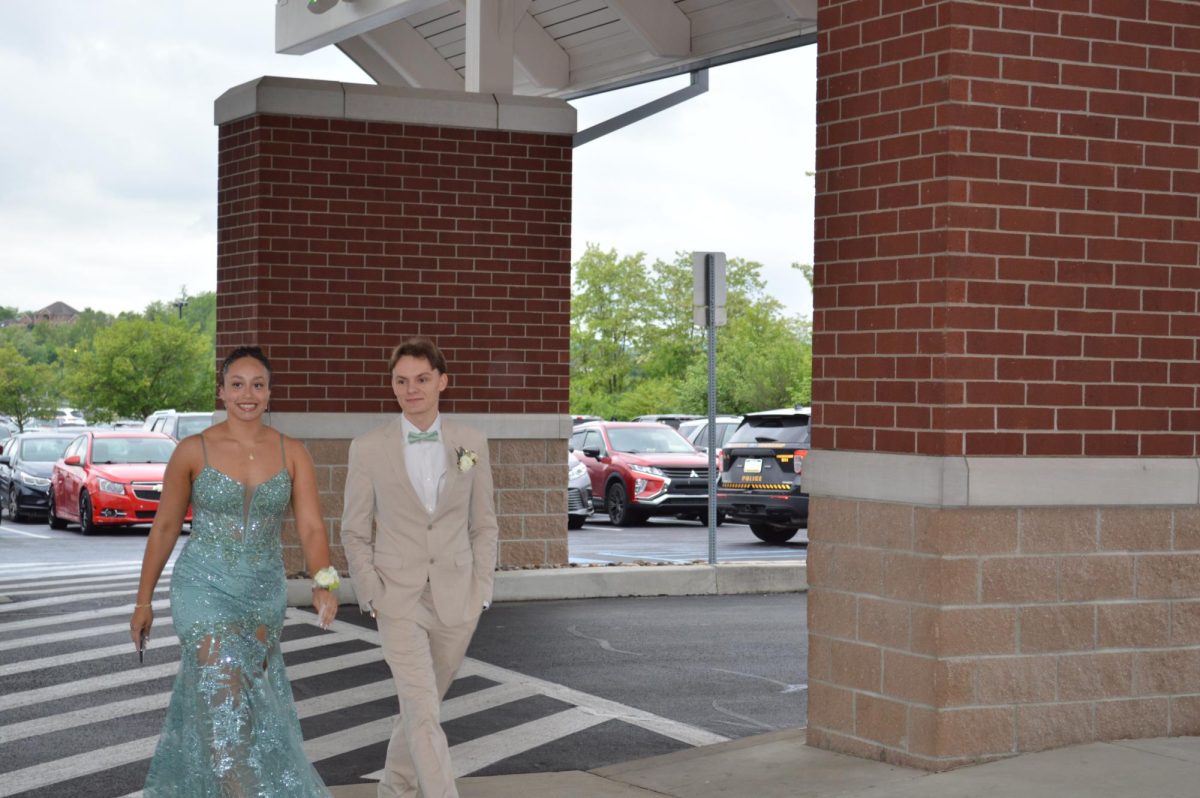 High school sweethearts.  Seniors Tanner Yoder and Mia Noel smile for the camera as they walk into their last dance. They have been together since Junior High and will now graduate together at the end of may. 