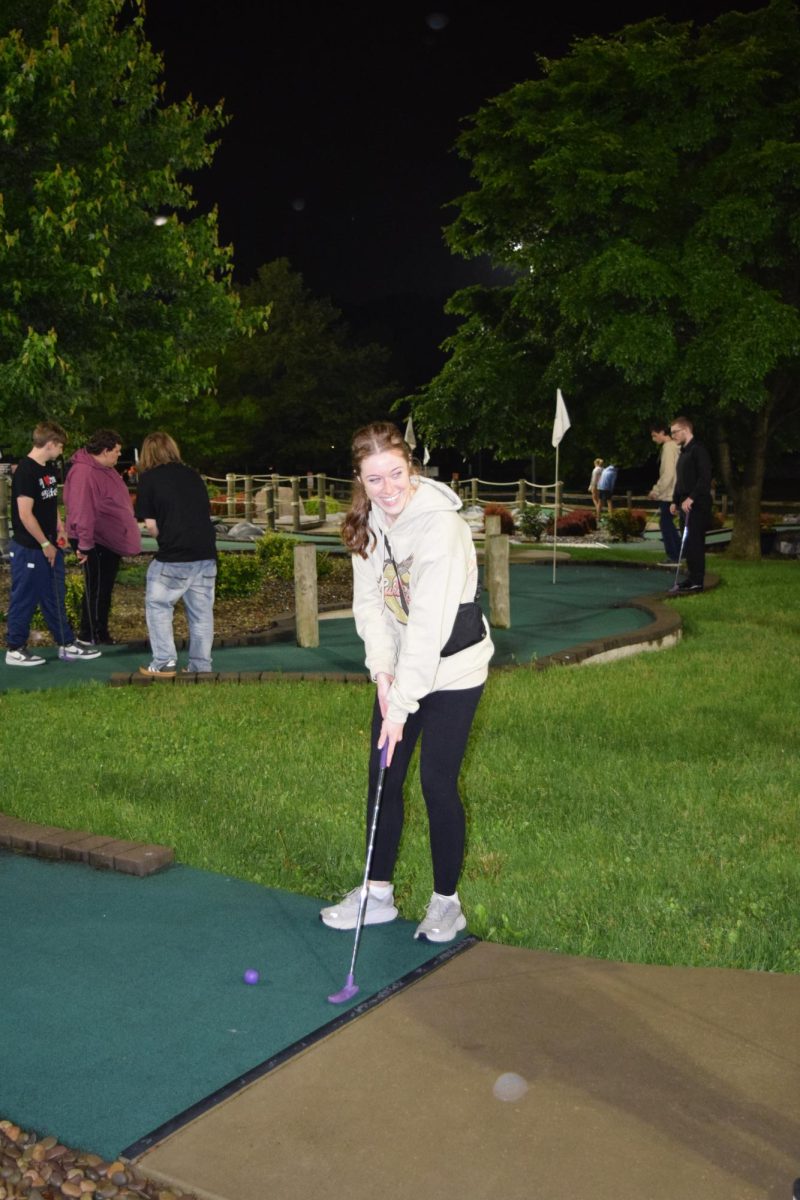 Hole in one. Senior Megan Shultz plays mini golf with a group of friends. Even after getting a hole in one she still came in last place. 