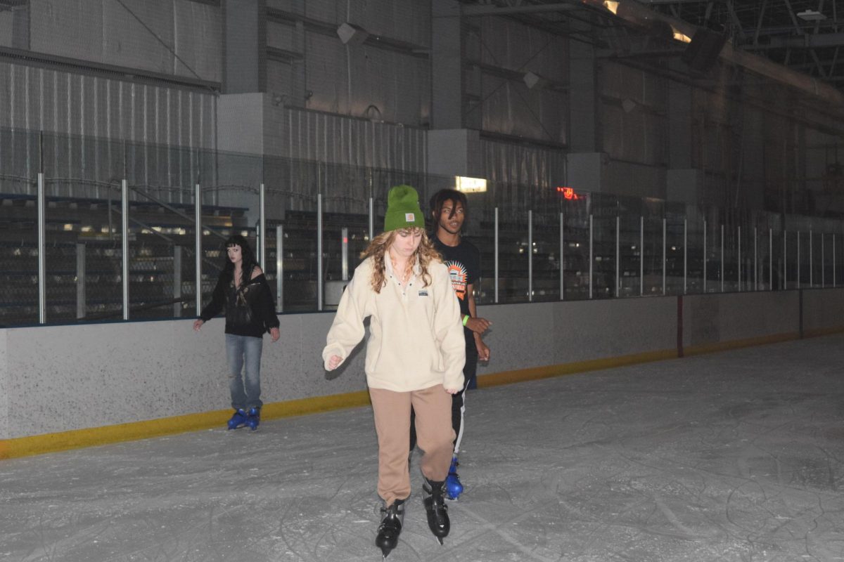 Focus on your feet.  Senior Maxxine Butterbaugh pays close attention to the floor as she skates around. Some students were pros at skating while others experienced their first time. 