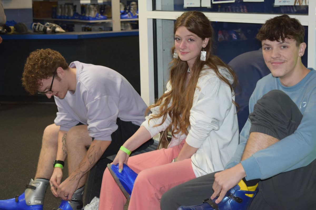 Lacing up. Senior Brian Beere and friend Gracie Crider pose for the camera as they get their skates on. Galactic ice gave free admission to all students during afterglo.