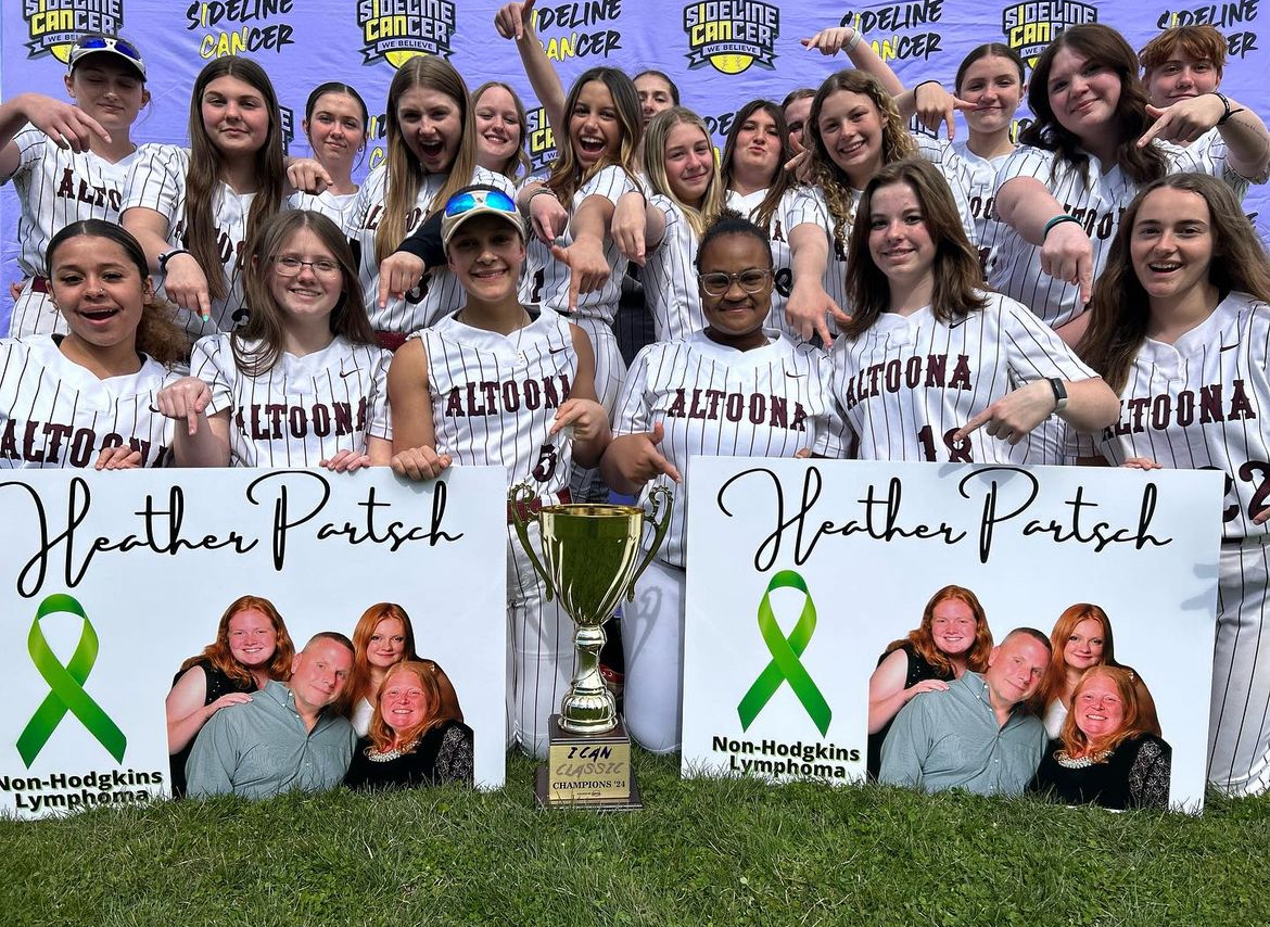 Feeling the love. The girls pose with their signs honoring science teacher Heather Partsch and her diagnosis. (Photo courtesy of Kaya Sprankle) 