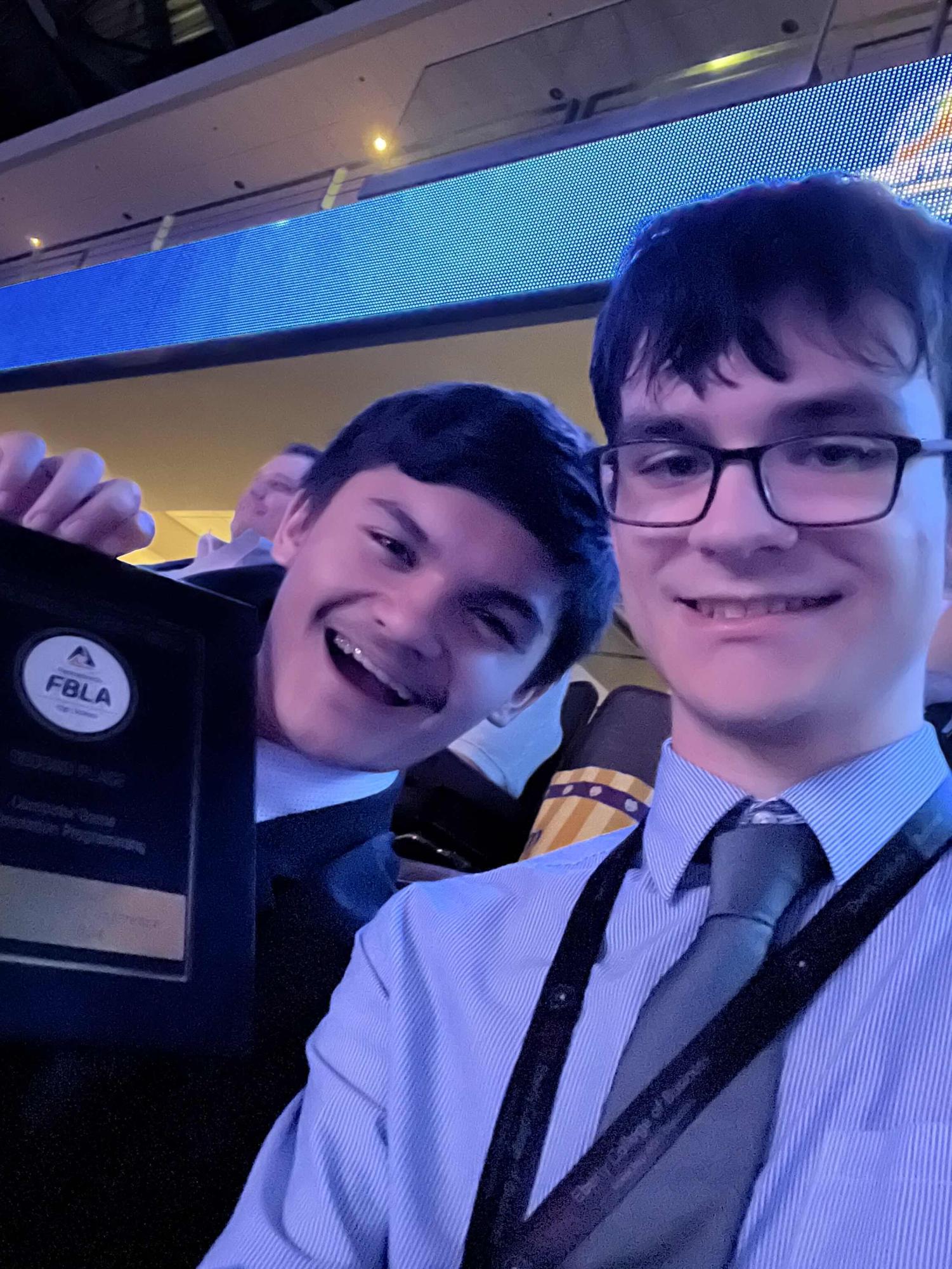 Climbing the steps. Yohn and Matosziuk celebrated their placement at the FBLA SLC after the awards ceremony on stage. (Courtesy of Connor Matosziuk)