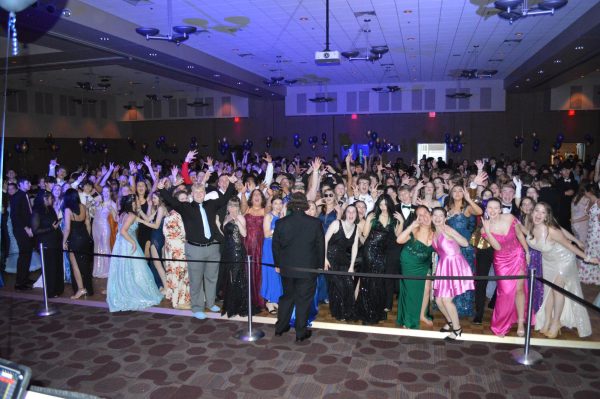 Lets get loud. Students get excited at prom as they pose for a big group photo. Everyone had a great time. 