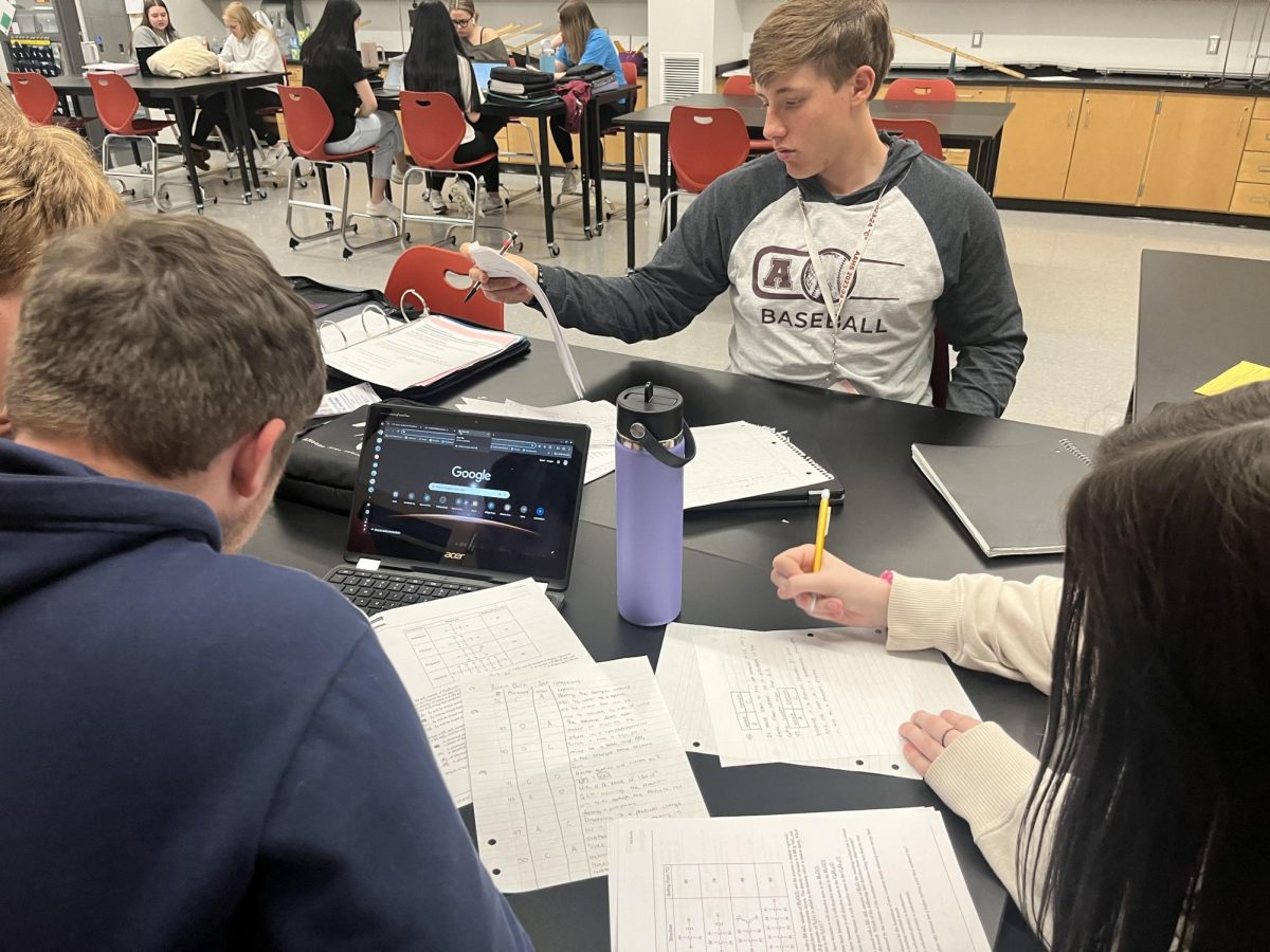 Fixer Upper. Junior Caleb Gibson and seniors Marcella Parker and Austin Burk complete test corrections for their Advanced Placement Chemistry Final. Students in the class were offered half of a point earned for each correction made .