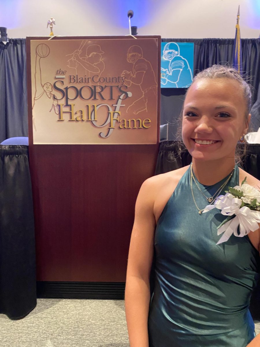 Prim and proper. Kravetz smiles brightly after receiving her $2,000 scholarship. She spent much of her time at the banquet with AAHS alumnus Rachel Gehret, who holds 8 school track and field records. 