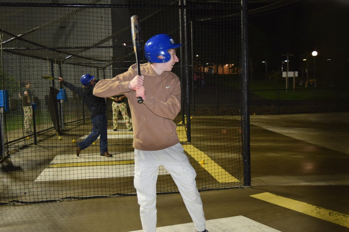 Strike out. Senior Ayden Miller steps into the batting cages as his activity during afterglo. Everyone was able to take turns doing each activity. 