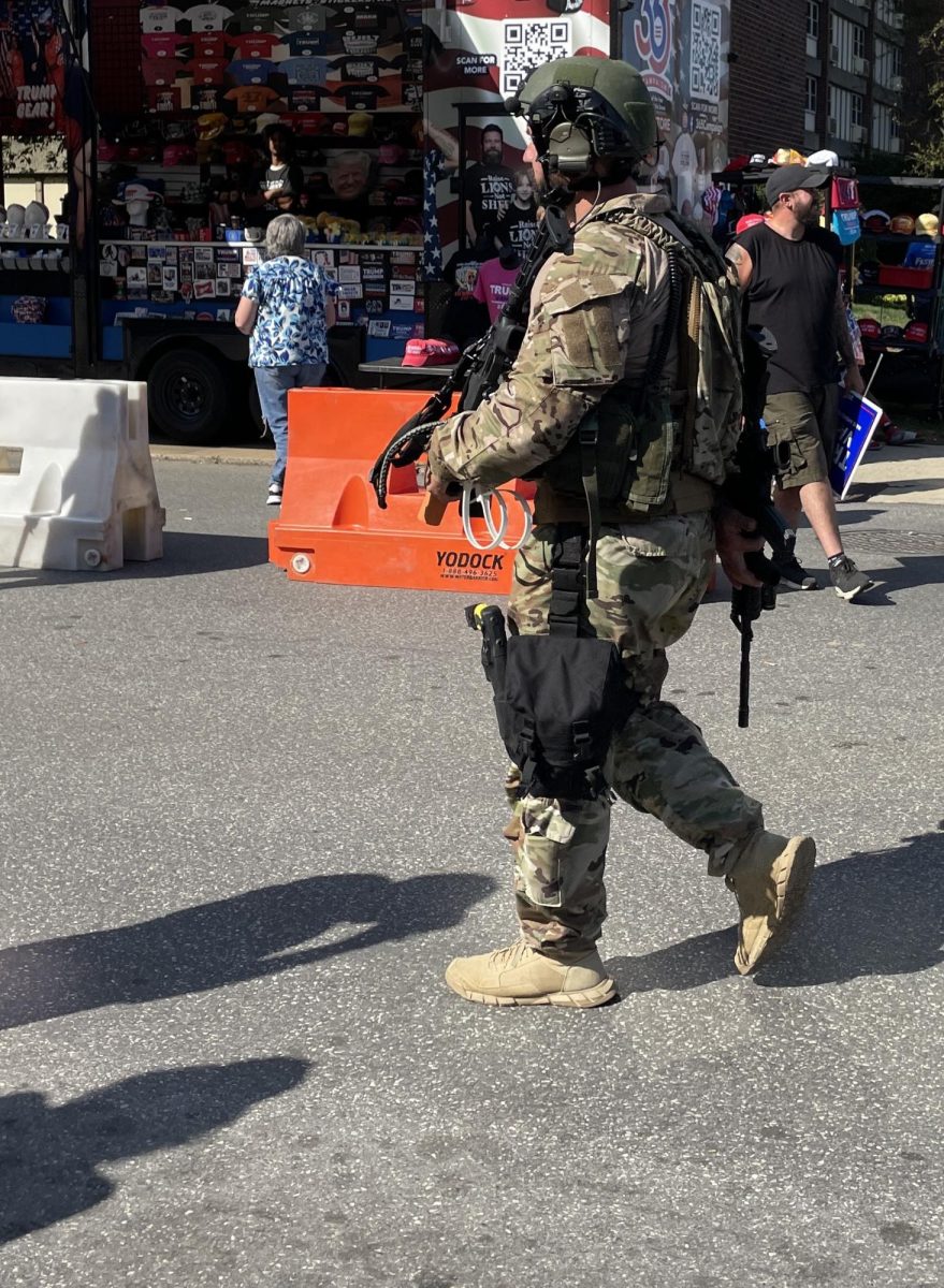 One of the many armed, militia looking members. 