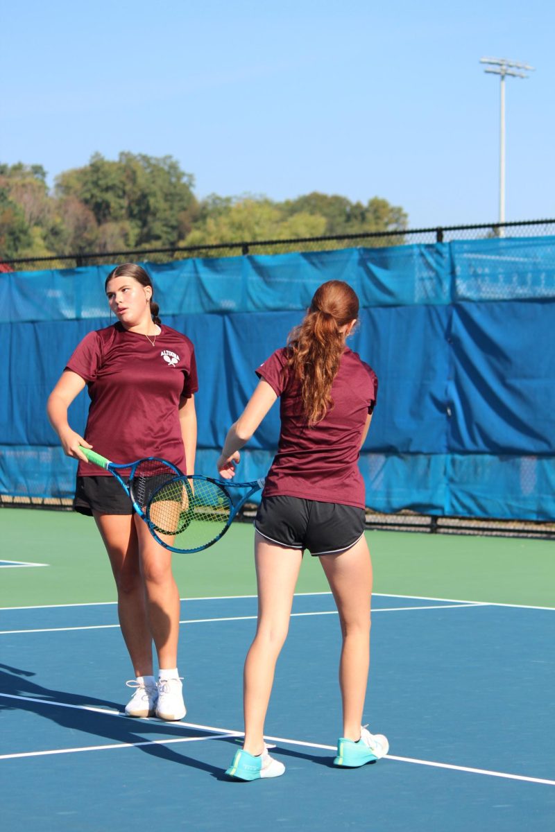 Hovan and S. Irwin tap rackets after scoring. They played Dubois at 10:30 a.m. 