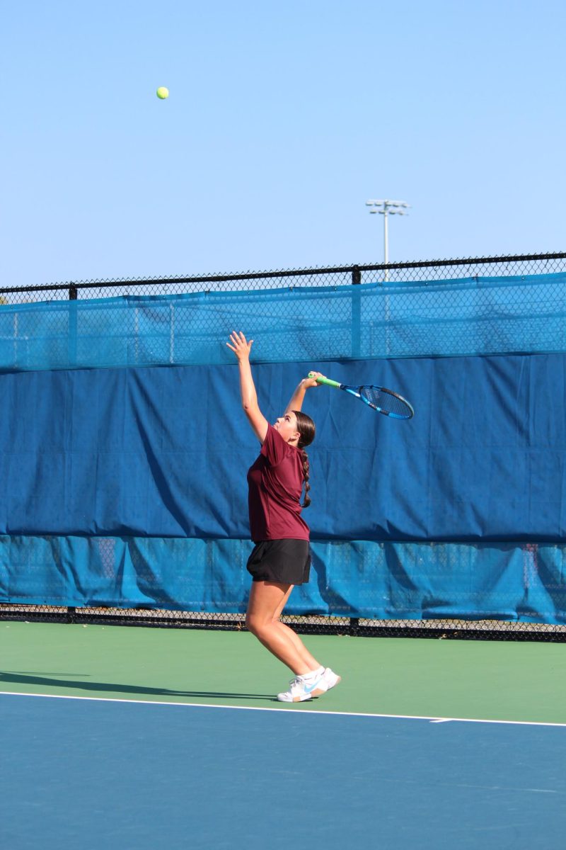 Hovan serves the ball. She played doubles against Tyrone with S. Irwin. 