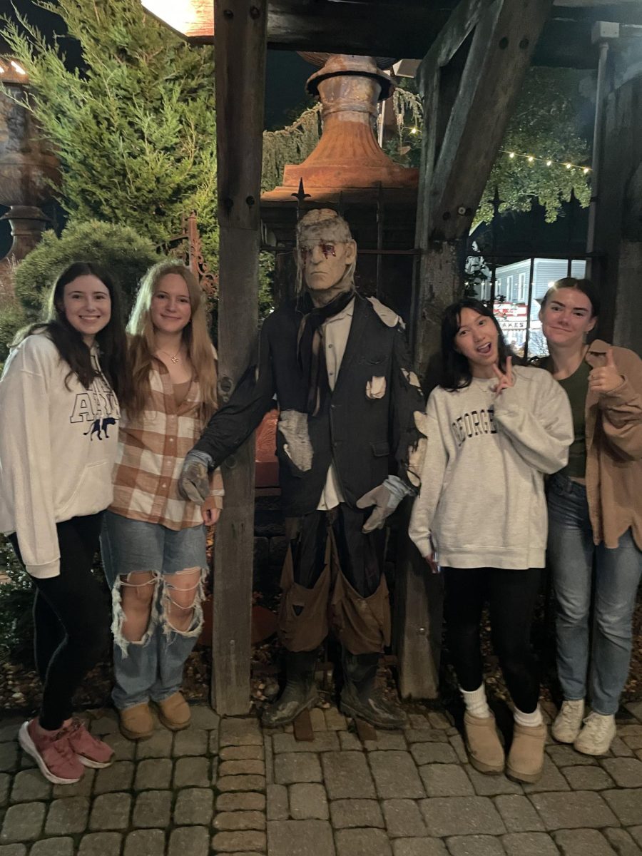 Monster mash. Juniors (from left to right) Tessa Easton, Margaret Brouse, Grace Hovan and Grace Long pose with a monster dummy at the end of their trip to "Field of Screams". The group visited all four attractions at the park, which included two haunted houses, one outdoor haunt and a haunted hayride. 