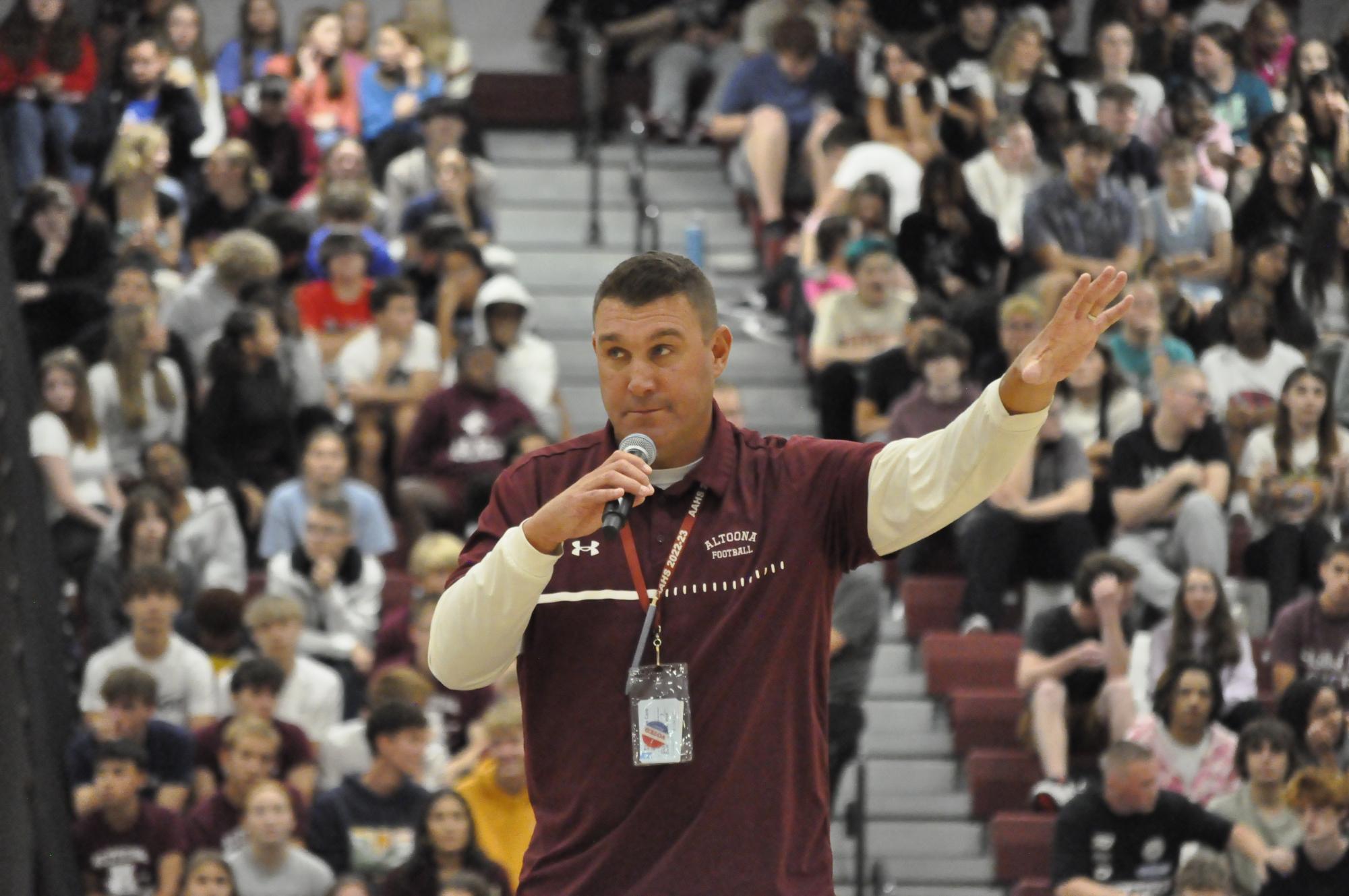 School spirit. Football coach Vince Nedimyer hypes up the crowd in the gym before the annual Hollidaysburg-Altoona football game. The entire student body packed into the bleachers for the pep rally.