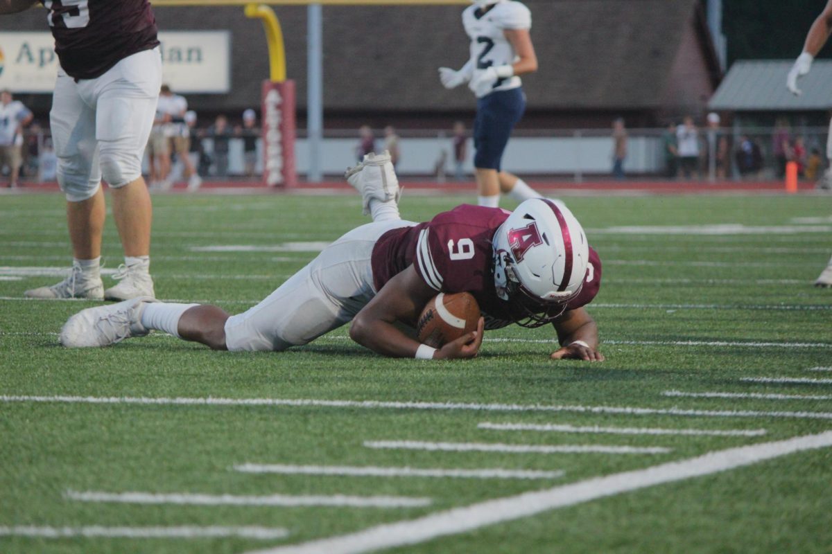 Junior Tykear Davis lands on the ground after catching the ball at a game on August 23. The homecoming game will be played against Harrisburg. 