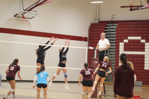 Defense. Blocking senior Ellaina Saylor, the opposing team jumps to make sure Saylor doesn’t get the point after spiking. 