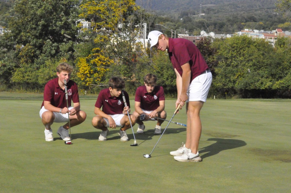 Watch and Learn. Junior Krieghoff Cumming is putting the ball to finish the hole. Operation Our Town is the largest match of the year. 